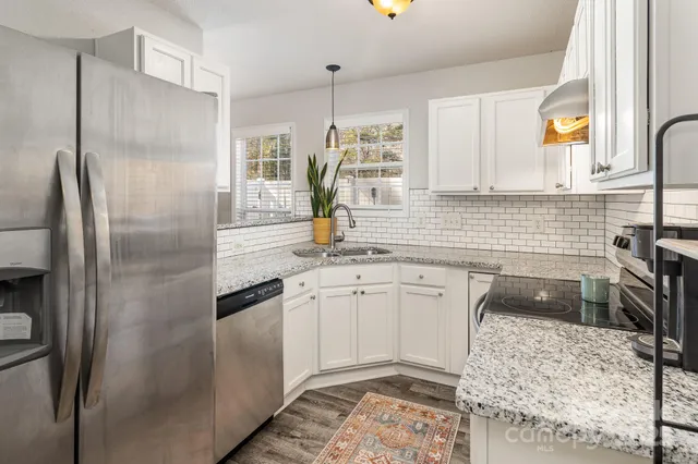 a kitchen with a refrigerator sink and microwave