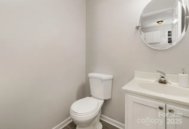 a bathroom with a sink mirror and toilet