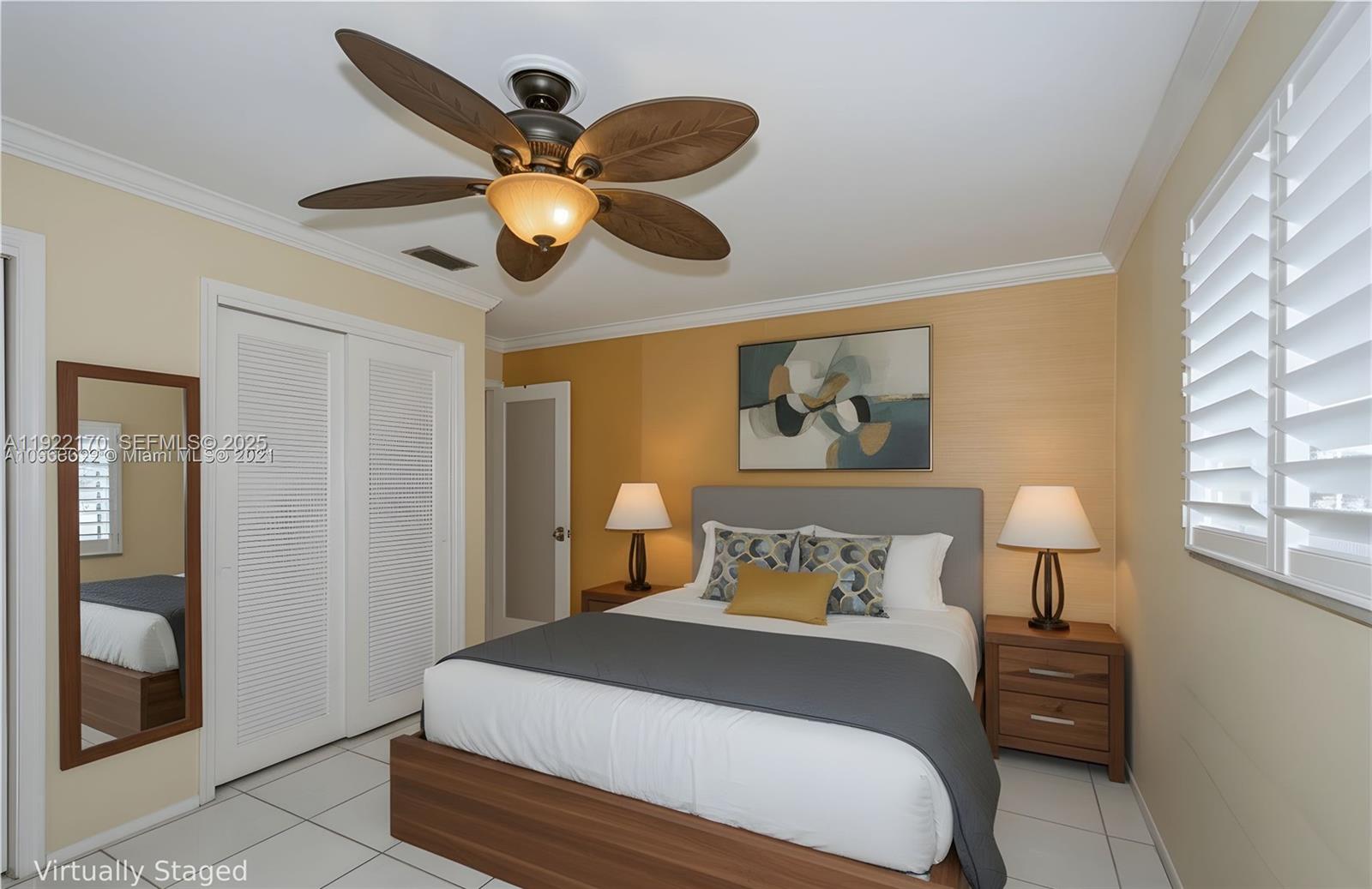4905 Northwest 49th Road Tamarac, FL 33319 - Photo 12 of 25 a bedroom with a bed and a painting on the wall