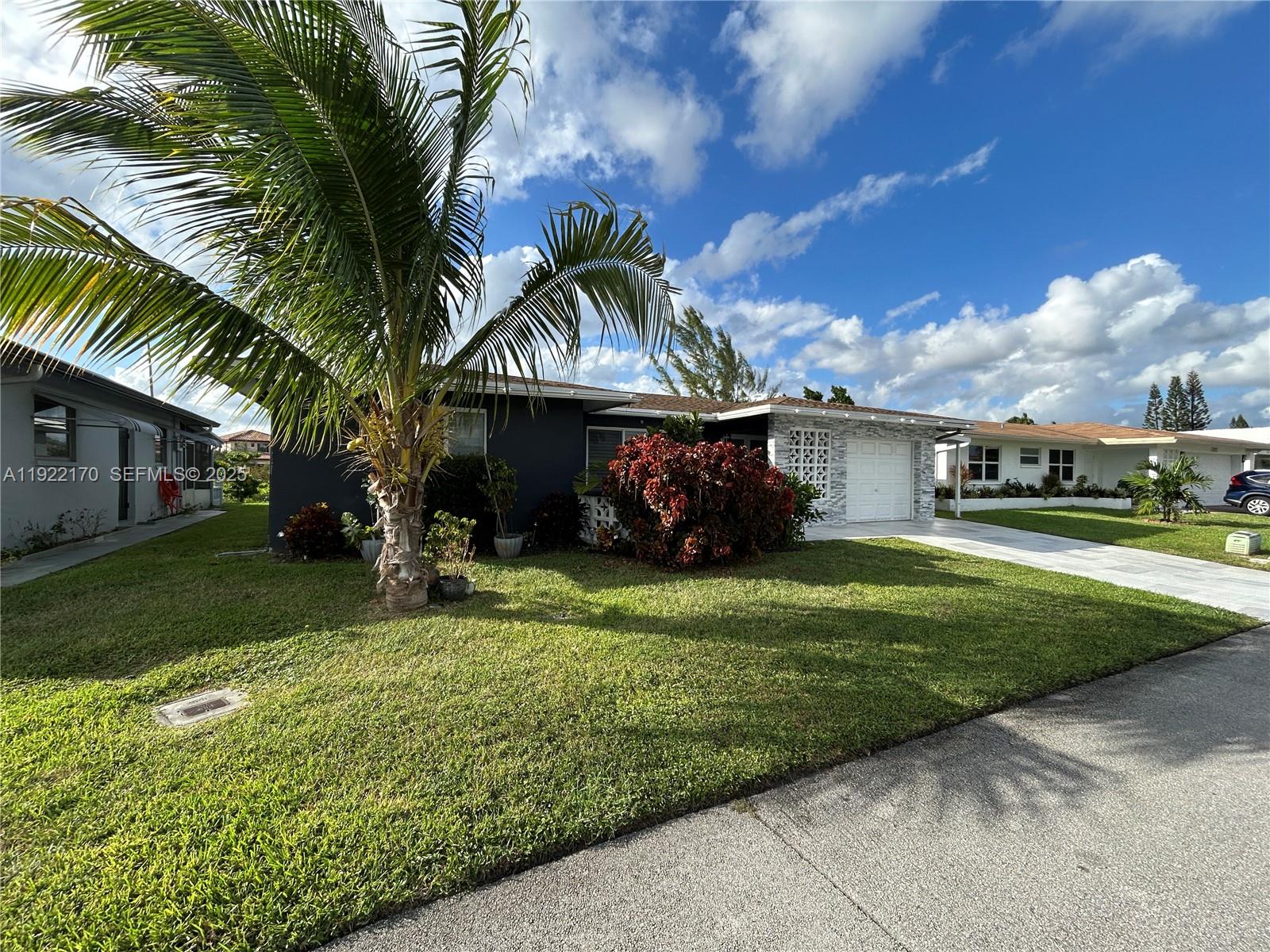 4905 Northwest 49th Road Tamarac, FL 33319 - Photo 18 of 25 a front view of a house with a garden