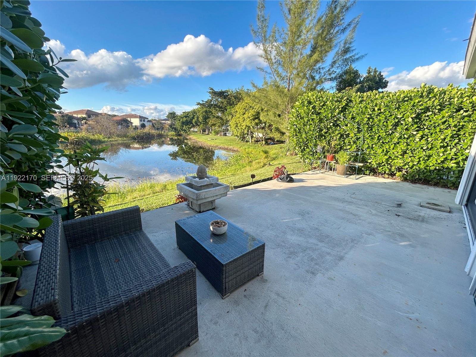 4905 Northwest 49th Road Tamarac, FL 33319 - Photo 22 of 25 a view of a terrace with wooden floor and a bench