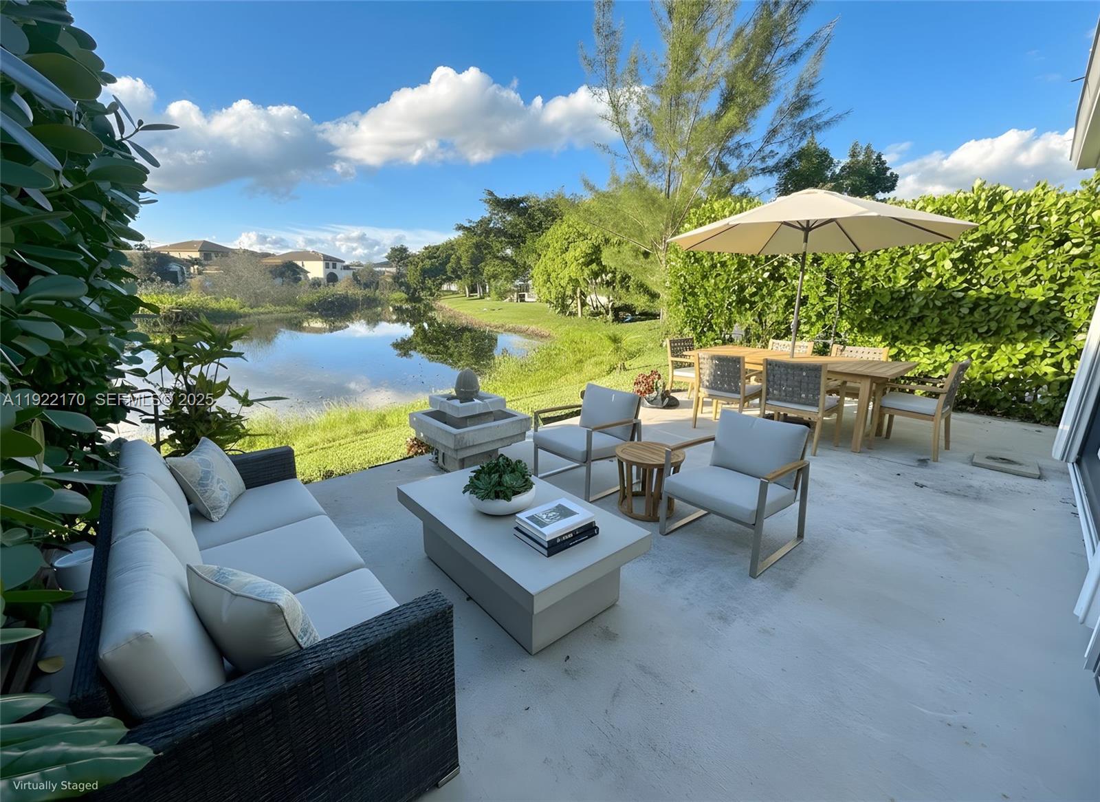 4905 Northwest 49th Road Tamarac, FL 33319 - Photo 3 of 25 a view of a patio with couches under an umbrella