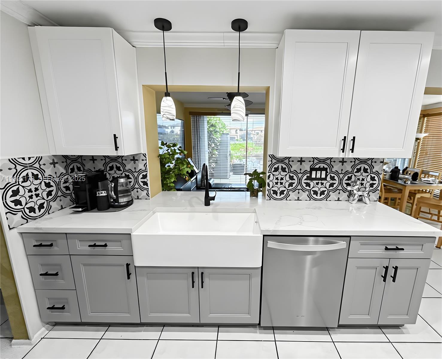4905 Northwest 49th Road Tamarac, FL 33319 - Photo 6 of 25 a kitchen with a white cabinets sink and white appliances
