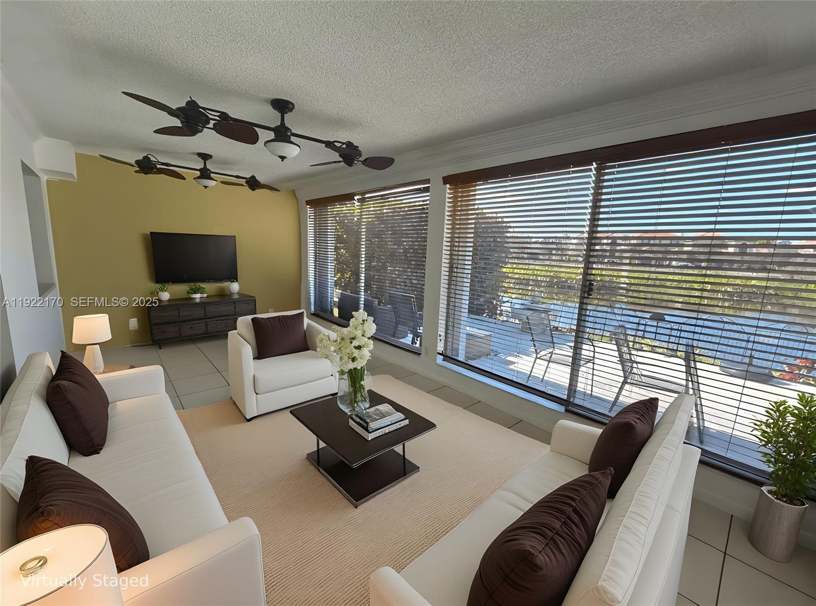 4905 Northwest 49th Road Tamarac, FL 33319 - Photo 10 of 25 a living room with furniture and a flat screen tv