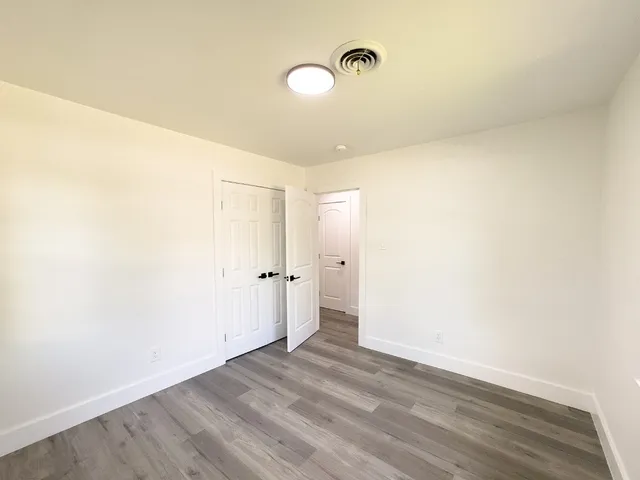 a view of a room with wooden floor