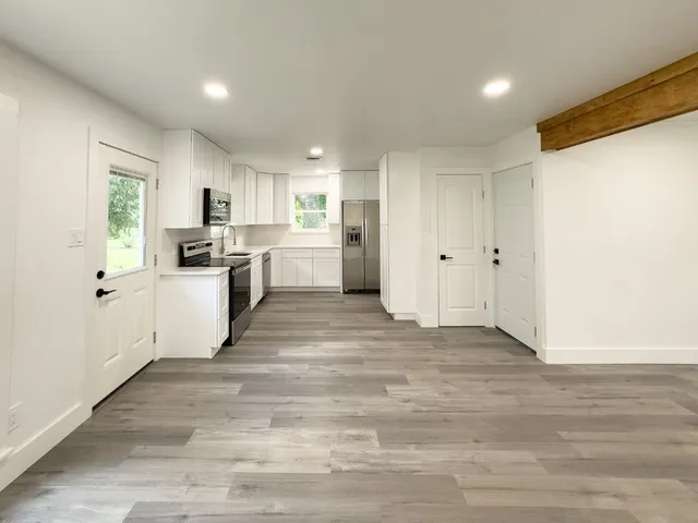 a view of a kitchen with microwave and cabinets