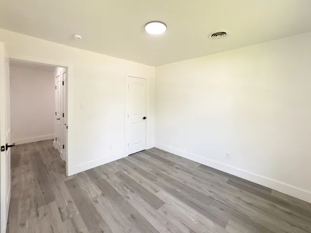 a view of a room with wooden floor