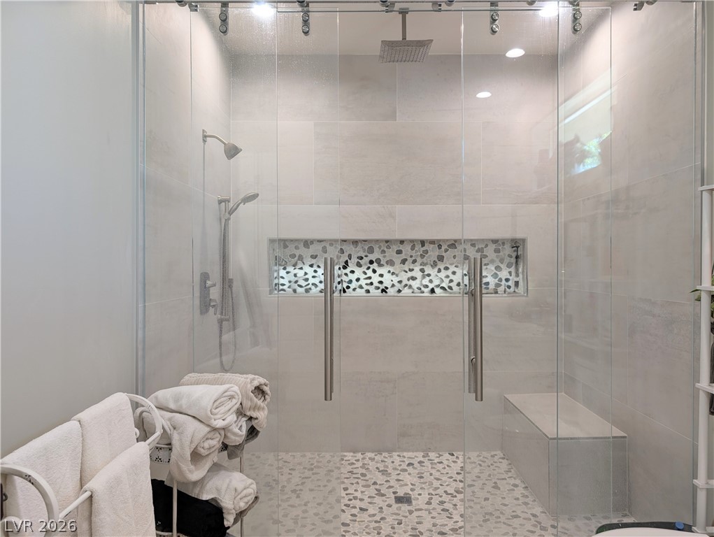251 Spring Heights Caliente, NV 89008 - Photo 18 of 27 This spacious shower features a unique stone tile floor and a convenient built-in bench.