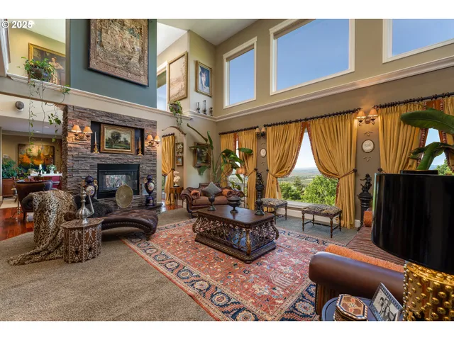 a living room with furniture a fireplace and a large window