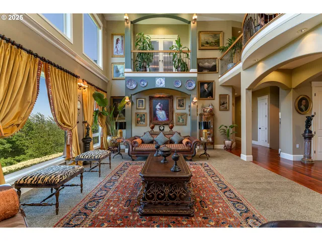 a living room with fireplace furniture and a large window