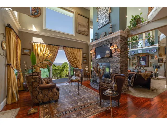 a living room with fireplace furniture and a large window