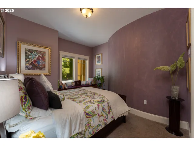 a bedroom with a bed dresser and a window