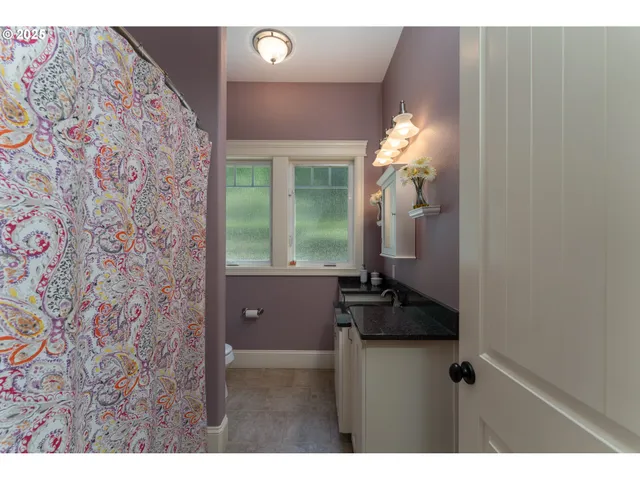 a bathroom with a granite countertop sink a vanity and a mirror