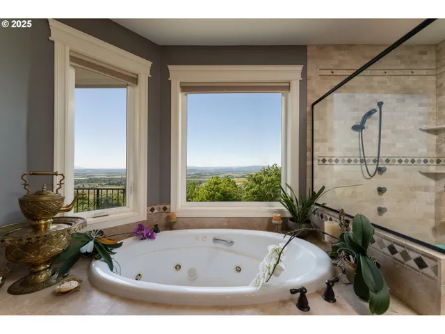a bathroom with a tub sink and mirror