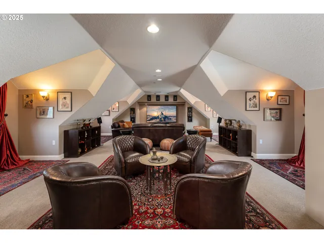 a living room with furniture kitchen view and a wooden floor
