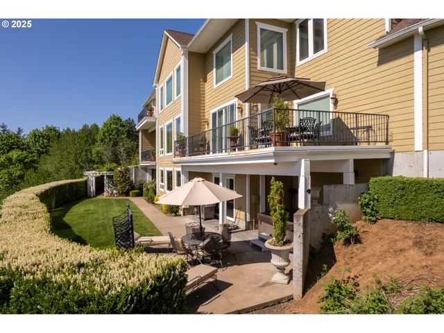 a view of a house with backyard porch and sitting area