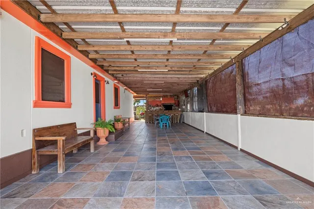 a view of a patio with table and chairs