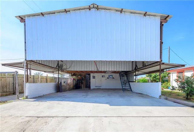 a view of a back yard with a wooden fence
