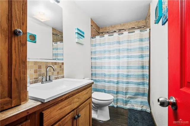 a bathroom with a sink toilet and shower