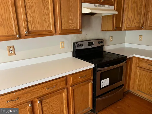 a kitchen with stainless steel appliances a stove and a microwave