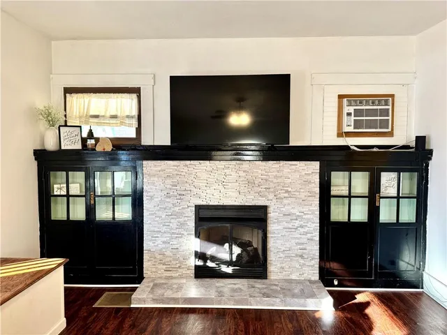 a living room with fireplace furniture and a flat screen tv