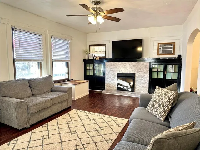 a living room with furniture flat screen tv and a fireplace