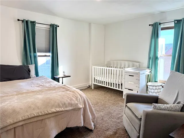 a bedroom with a bed couch and a window