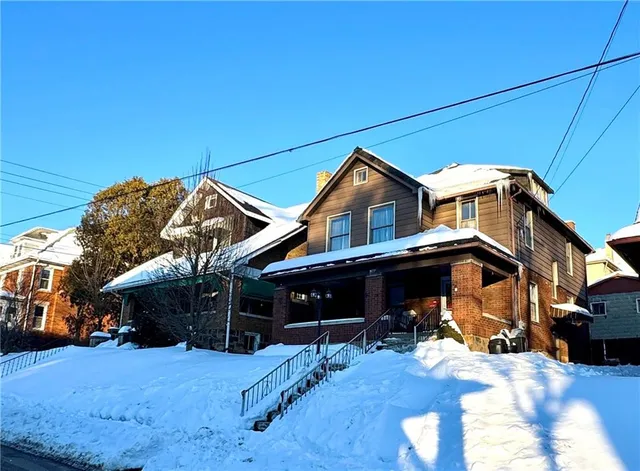 a view of a house with a yard porch and furniture