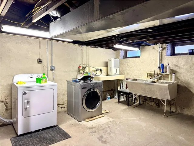 a utility room with cabinets dryer and washer