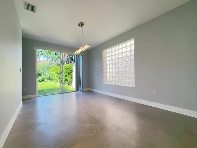 a spacious bathroom with a double vanity sink a large mirror a bathtub and window