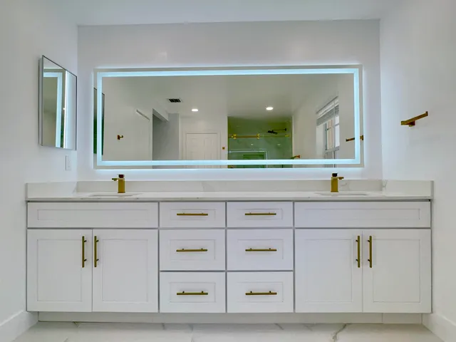 a bathroom with a sink vanity and mirror