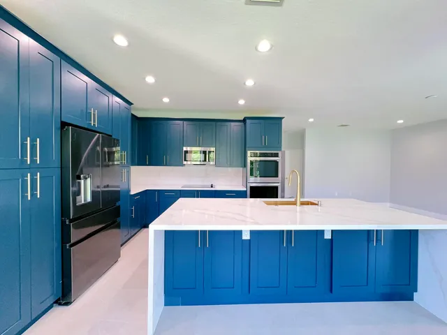 a large kitchen with kitchen island a island wooden cabinets and stainless steel appliances