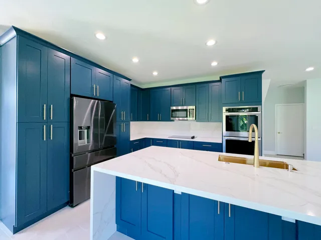 a kitchen with stainless steel appliances a refrigerator and a microwave