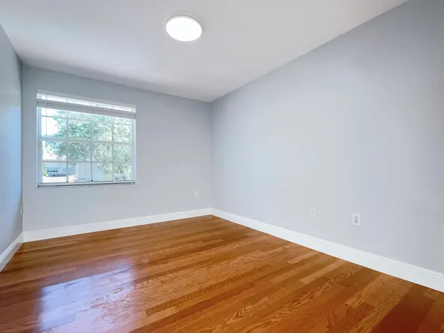 a view of a room with wooden floor and small space
