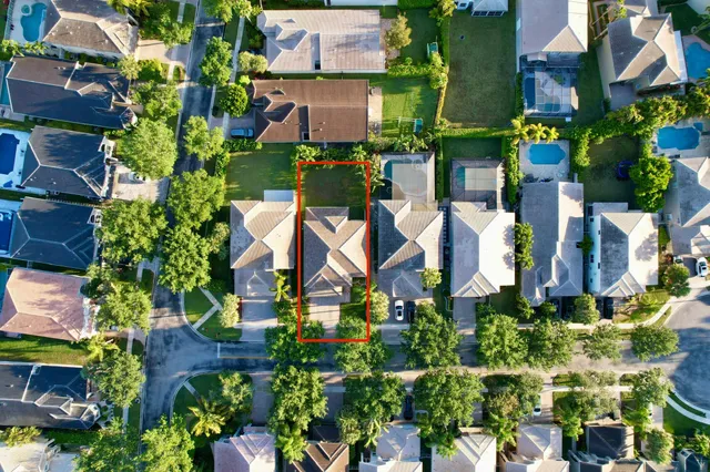 an aerial view of a house with yard swimming pool and outdoor seating