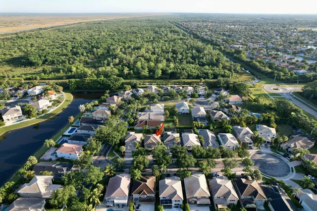 an aerial view of a house with a yard and garden