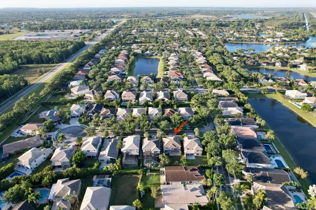 an aerial view of residential houses with outdoor space and trees