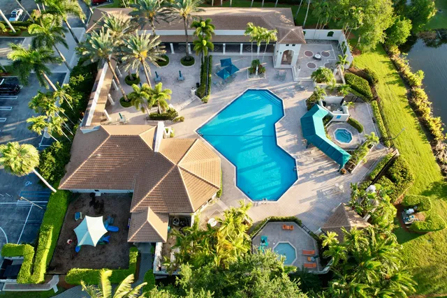 a swimming pool with outdoor seating and yard