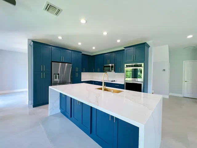 a kitchen with wooden cabinets and stainless steel appliances