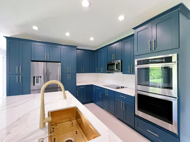 a kitchen with wooden cabinets and stainless steel appliances
