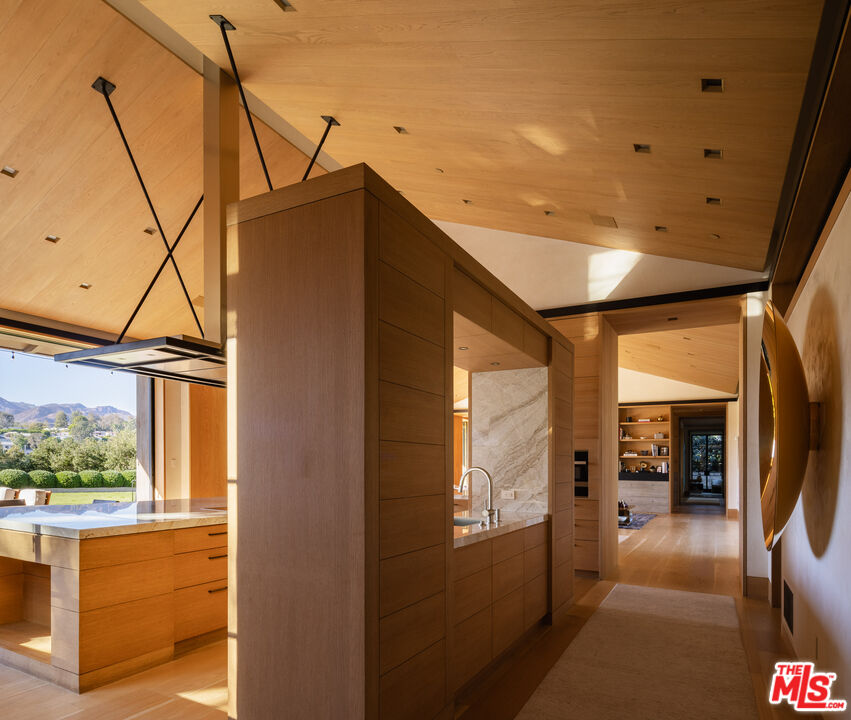 859 Woodacres Road Santa Monica, CA 90402 - Photo 18 of 54 a hallway with sliding door and wooden floor