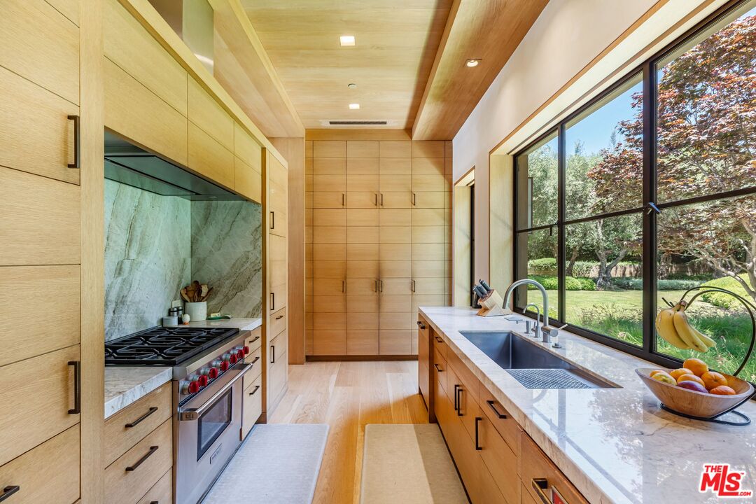 859 Woodacres Road Santa Monica, CA 90402 - Photo 19 of 54 a kitchen with sink a stove and cabinets