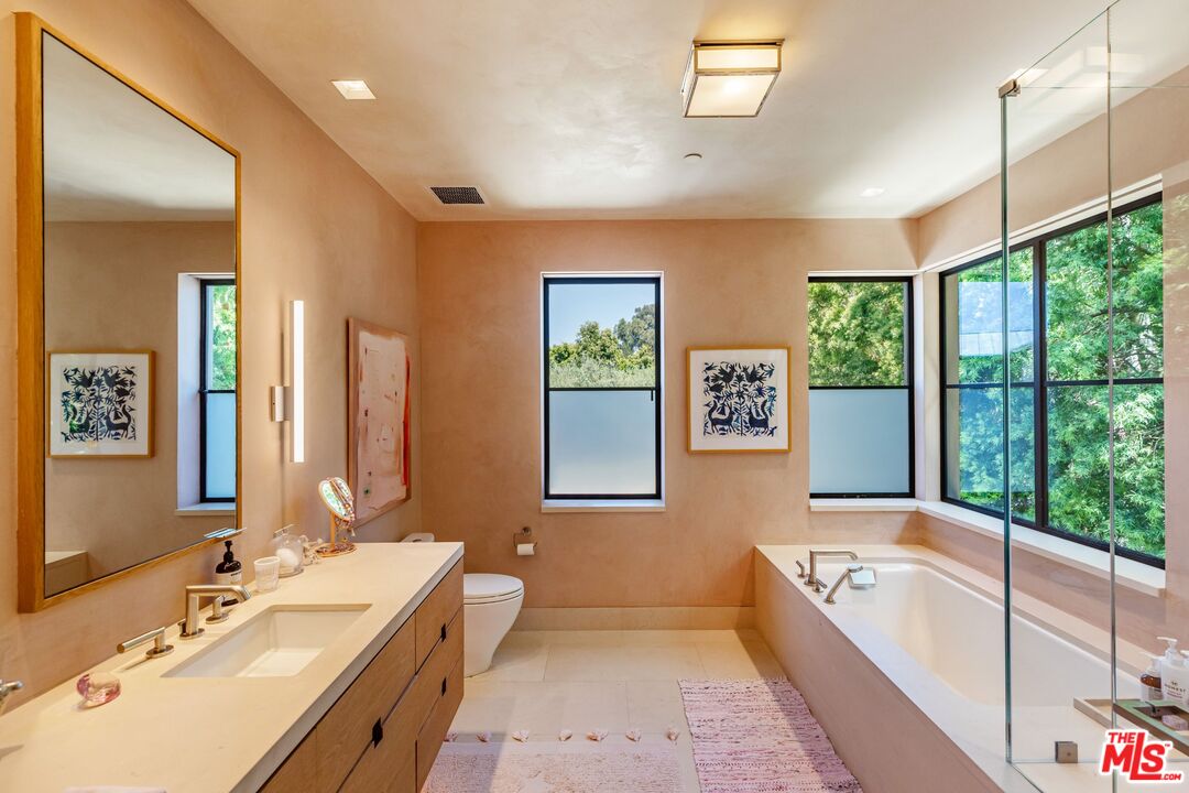 859 Woodacres Road Santa Monica, CA 90402 - Photo 28 of 54 a bathroom with a tub a sink and mirror