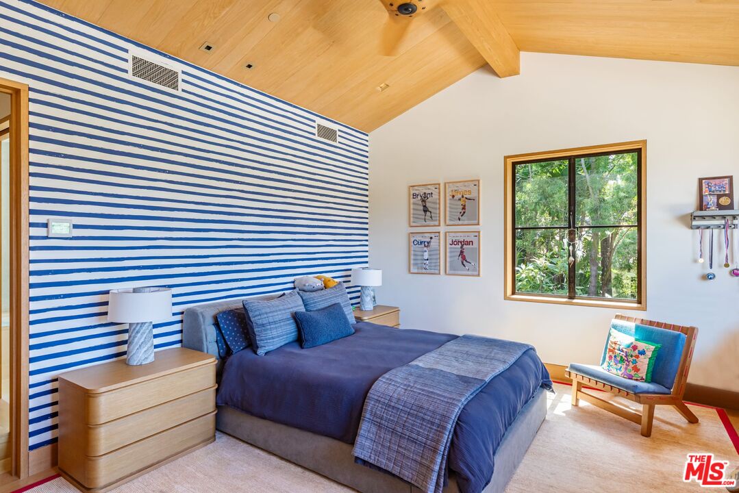 859 Woodacres Road Santa Monica, CA 90402 - Photo 29 of 54 a bedroom with a bed and a window