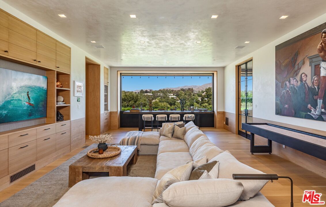 859 Woodacres Road Santa Monica, CA 90402 - Photo 34 of 54 a living room with furniture couches and a flat screen tv