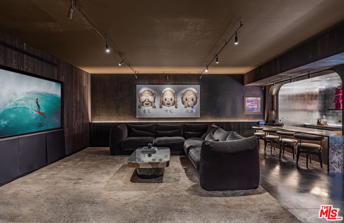 859 Woodacres Road Santa Monica, CA 90402 - Photo 41 of 54 a living room with furniture a projector and a flat screen tv