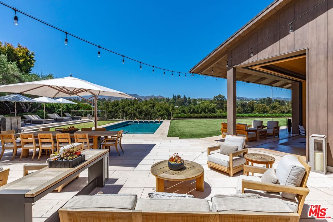859 Woodacres Road Santa Monica, CA 90402 - Photo 46 of 54 a view of swimming pool with lounge chairs in patio