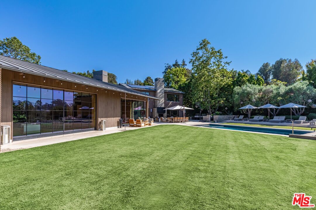 859 Woodacres Road Santa Monica, CA 90402 - Photo 48 of 54 a view of a patio with swimming pool table and chairs