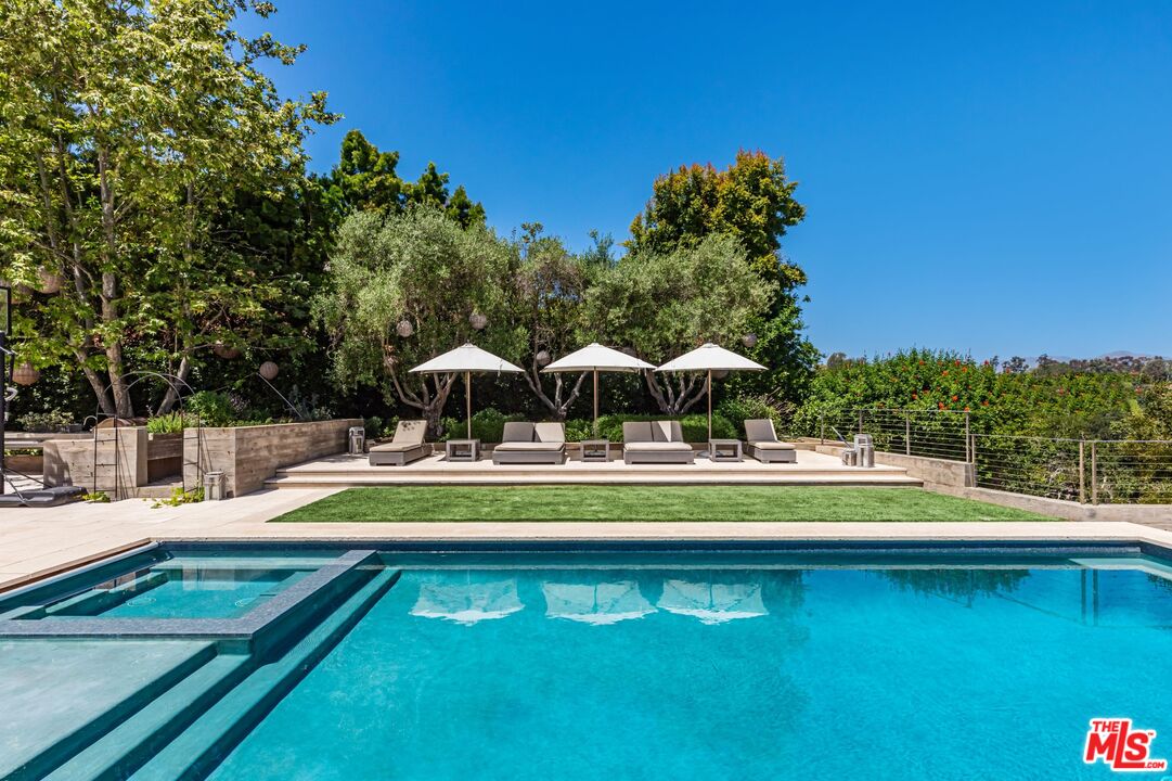 859 Woodacres Road Santa Monica, CA 90402 - Photo 49 of 54 a view of a swimming pool with chairs