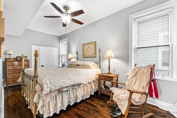 a bedroom with bed and windows